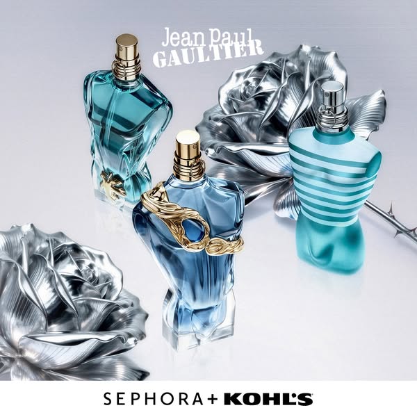 The ad features three Jean Paul Gaultier men's cologne bottles in the shape of a muscular male torso. They are arran