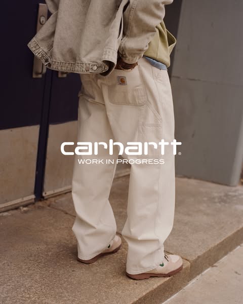This image ad showcases a pair of cream colored corduroy pants from Carhartt Work In Progress (WIP). The model is also w
