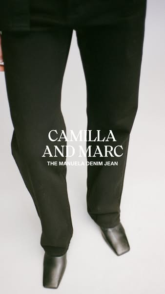 This image ad showcases a pair of black denim jeans from Camilla and Marc. The camera focuses on the jeans and a pair of