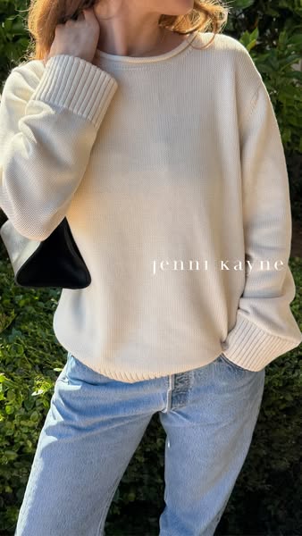 A woman is shown wearing a white Jenni Kayne sweater and jeans.