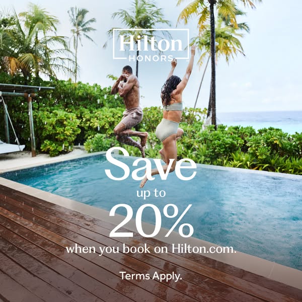 This image ad for Hilton Honors features a man and woman jumping into a pool at a tropical resort. The ad promotes savin