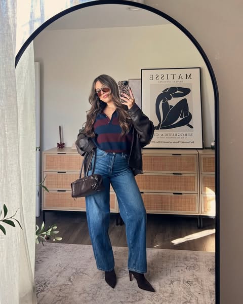 This image ad features a woman taking a mirror selfie in a stylish outfit. The ad is likely targeting young women intere