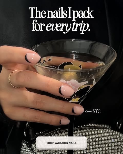 An image ad showcases a woman's hand holding a cocktail glass. The nails of her hand are done in a trendy fashion wi