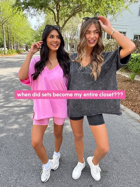 This ad features two women posing outside on a sunny day wearing matching lounge sets. A text overlay in the middle of t