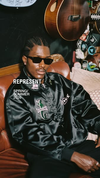 This image ad showcases a man wearing a black satin jacket with graphic designs, promoting the Represent brand and its S