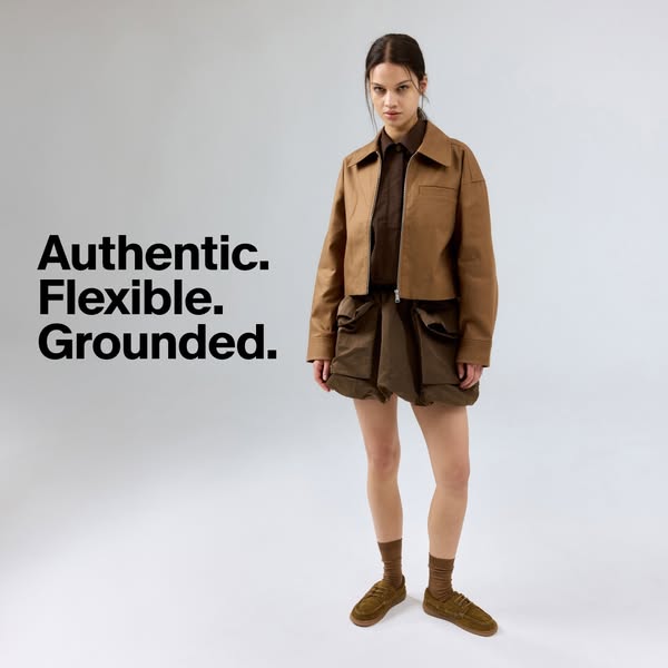The ad features a model wearing various apparel items and uses words to describe the brand's values.