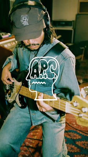 The image ad features a man playing an electric guitar, wearing a denim jacket and a baseball cap, with a white logo ove
