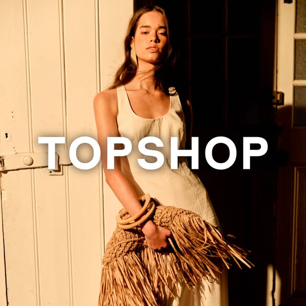 This is a high-quality image ad for Topshop apparel featuring a model wearing a simple white dress and holding a straw f