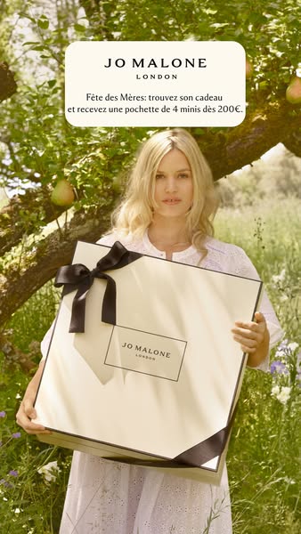 This Jo Malone ad features a woman holding a large gift box in a sun-drenched outdoor setting. The ad highlights a Mothe