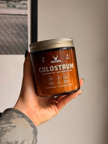 This image ad showcases a Heart & Soil colostrum supplement. The visual focuses on the product itself, emphasizing i