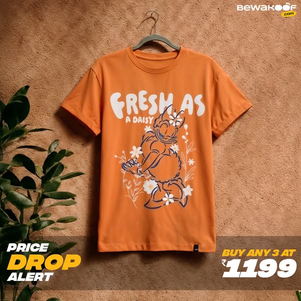The ad features a t-shirt with a cartoon illustration, presented with a price drop alert and a bulk purchase offer.