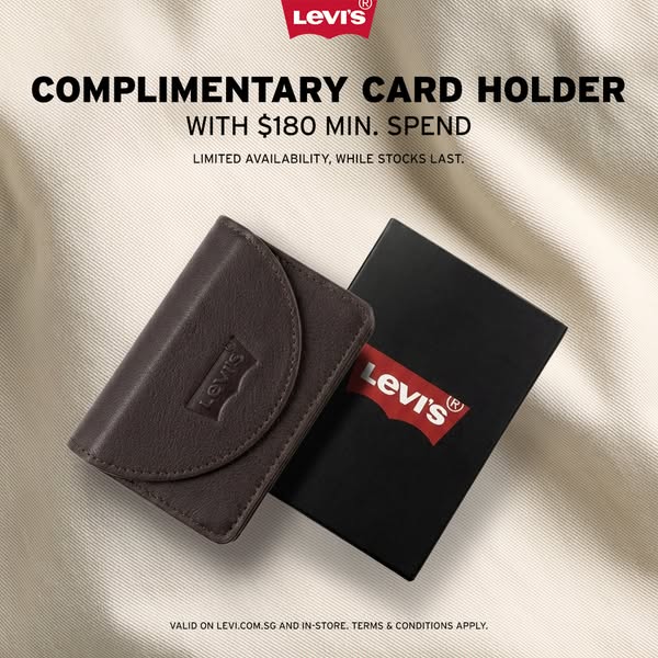 This ad promotes a complimentary Levi's card holder with a minimum purchase of $180, available while supplies last.