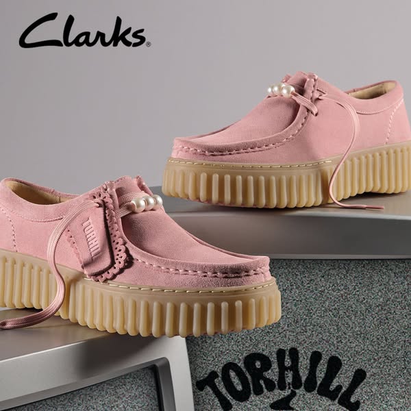 This ad showcases the Clarks Torhill shoe in pink suede with a platform sole. The ad highlights the shoe's unique de