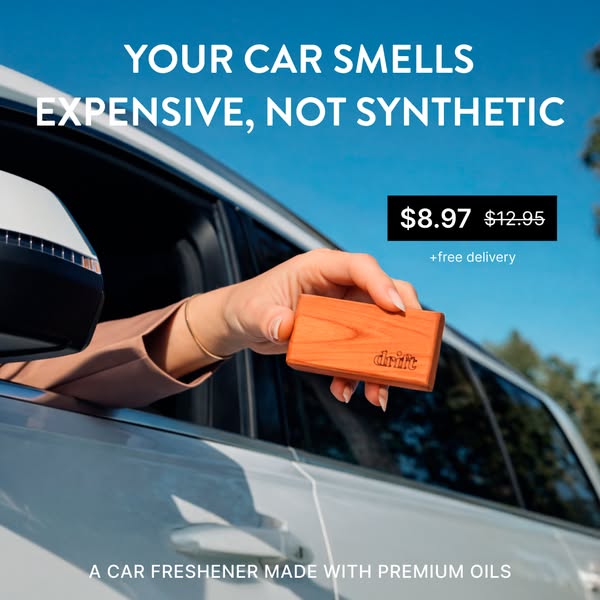 This ad showcases a car air freshener made with premium oils. It features a hand holding the air freshener outside a car