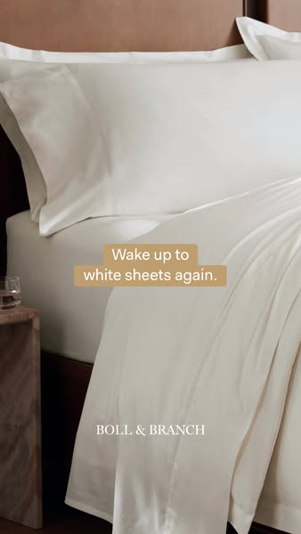 Ad for Boll & Branch brand sheets focusing on the comfort of white sheets. The advertisement's image shows a clo