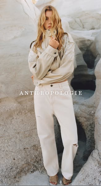 This Anthropologie ad features a blonde model posing in front of a rocky background, showcasing the brand's clothing