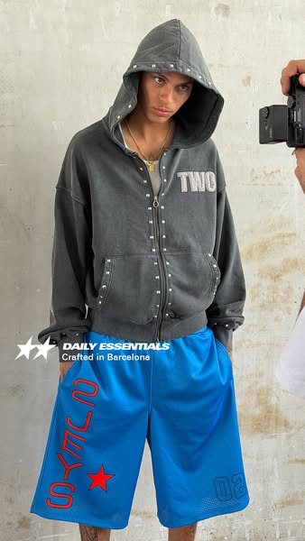 A product ad featuring a person wearing a grey hoodie and blue shorts.