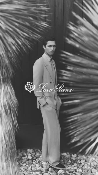 This image ad features a black-and-white portrait of a man wearing a suit by Loro Piana.