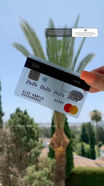 This image ad for N26 features a clear debit card held in front of a sunny, outdoor background. The ad highlights the ca