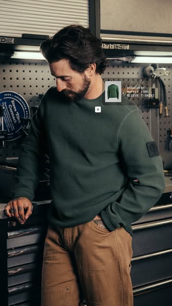 The ad features a man wearing a Dissident waffle long sleeve t-shirt. The product is showcased with a tag identifying it