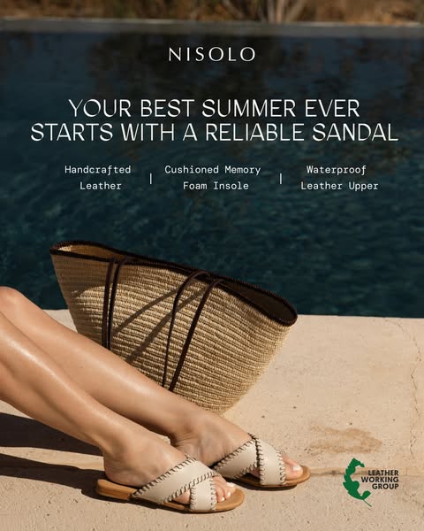 This image ad for Nisolo sandals features a woman's legs and feet wearing a light-colored sandal, with a straw bag a