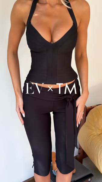 The ad features a woman wearing a black halter top and low-rise capri pants. The ad appears to be selling the bottoms si