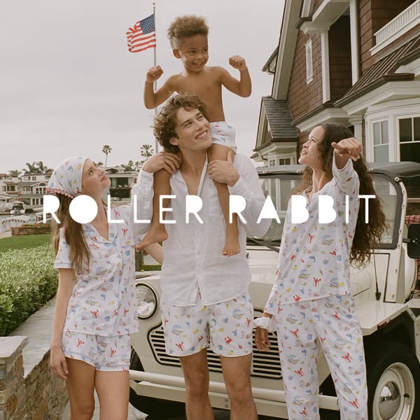 This ad features a family showcasing Roller Rabbit pajama sets in front of a vehicle and home. The scene is lifestyle-or