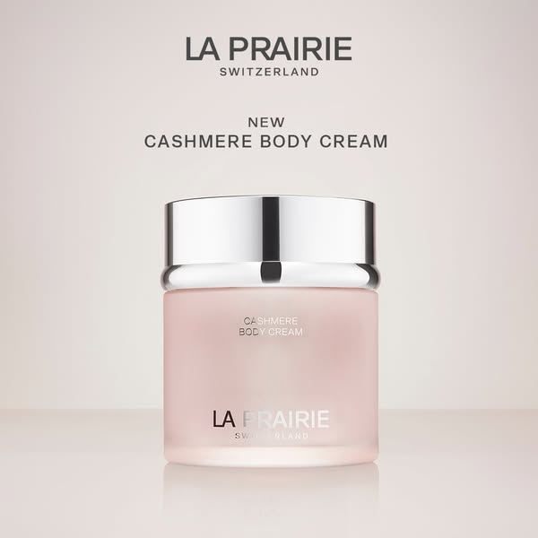 A minimalist ad for La Prairie's new Cashmere Body Cream, featuring a single product shot against a soft, gradient b