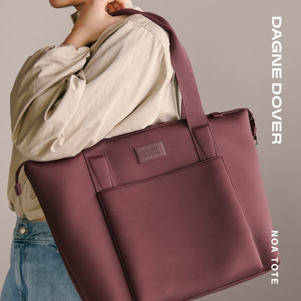 This image ad showcases the Dagne Dover Noa Tote in a deep red-purple color. The image focuses on the bag and how it han