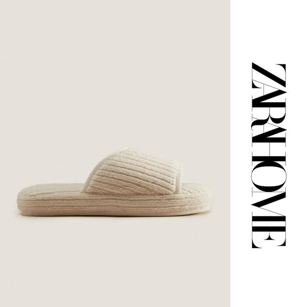 This ad showcases a single beige slipper from ZARA Home against a neutral background, emphasizing the brand's minima