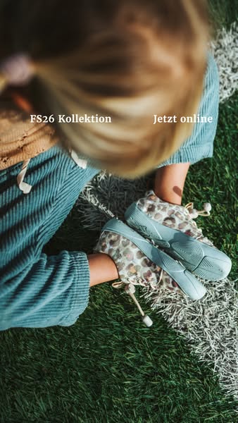 This ad is for a brand's new collection of shoes. The ad features a child sitting on grass and wearing the shoes.