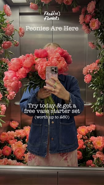 This image ad for Freddie's Flowers features a person taking a selfie with a bouquet of peonies in an elevator decor