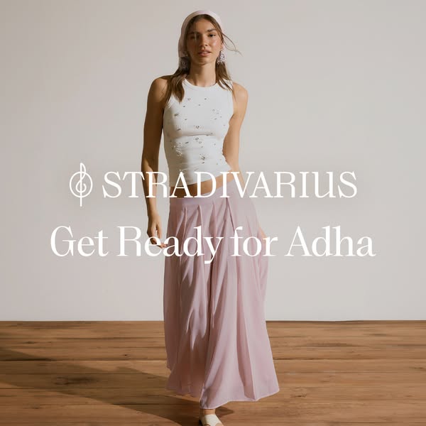 This ad features a full shot of a woman modeling clothing from Stradivarius. She is wearing a white tank top and a long,