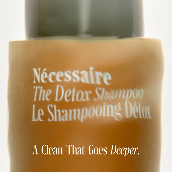 This ad features a close-up shot of a Nécessaire The Detox Shampoo bottle against a clean, white background. The focus i