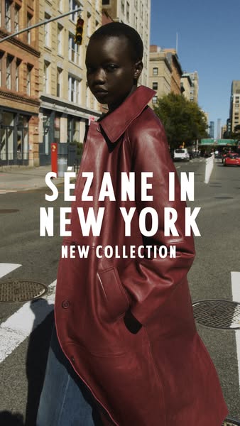 This image ad for Sézane features a model wearing a red leather coat from the new collection while walking in New York C