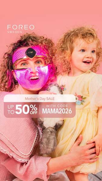 This ad is for Foreo's Mother's Day sale. A woman wearing a pink light therapy mask smiles while holding a young