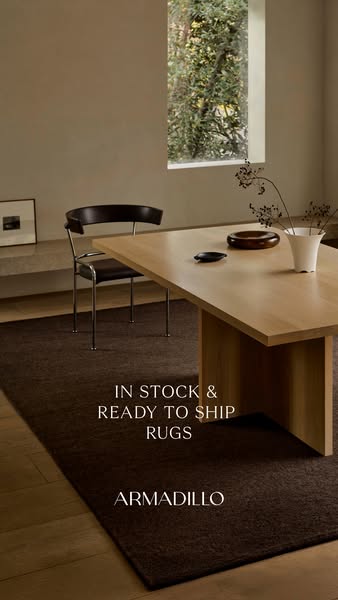 This image ad for Armadillo rugs showcases a dark brown rug in a neutral, modern interior. The ad emphasizes that the ru