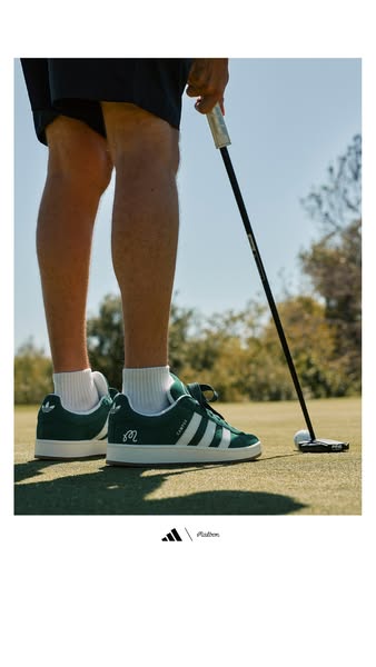 This image ad shows a low angle of a person preparing to play a golf ball with a golf club. The person is wearing Adidas