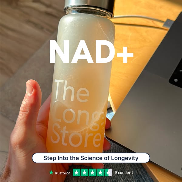 This image ad showcases The Long Store's NAD+ product. A hand holds the water bottle product in front of a laptop wi
