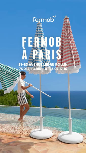 This image promotes Fermob parasols with a lifestyle shot of a man carrying one of the parasols while walking barefoot n