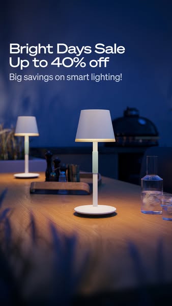 This image ad promotes a sale on smart lighting, showcasing a modern table lamp in an outdoor setting to appeal to custo