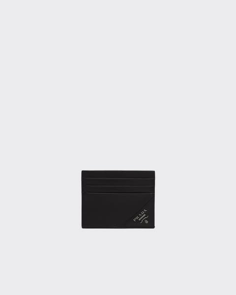 This ad features a black Prada card holder on a light gray background. The ad is simple and elegant, highlighting the lu