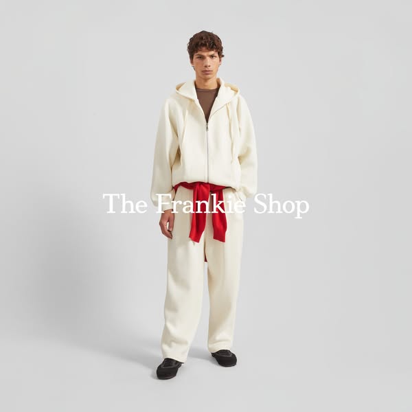 This ad showcases apparel from The Frankie Shop, featuring a model wearing a matching hoodie and pants set with a red sa