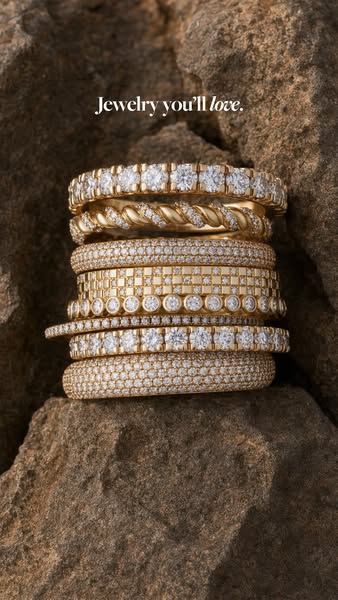 This image ad features a stack of gold and diamond rings against a natural rock backdrop, promoting the jewelry as desir