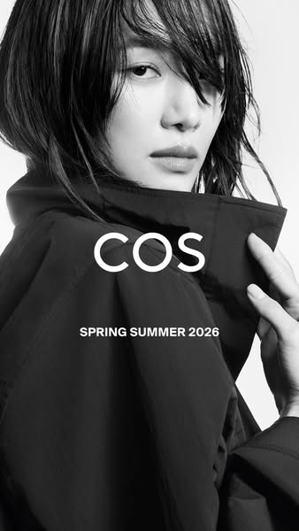 A high-fashion ad introducing COS's Spring/Summer 2026 collection, featuring a close-up shot of a model wearing a da