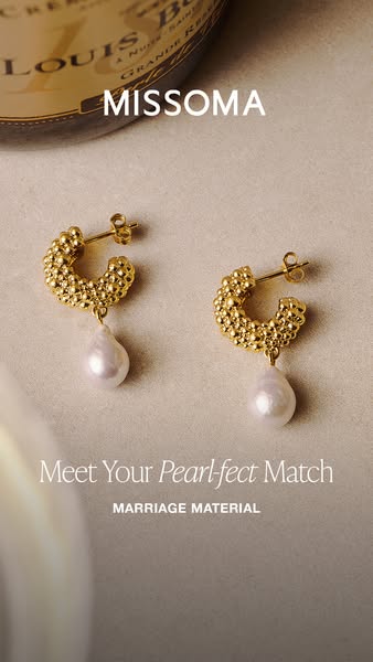 The image ad features a pair of gold Missoma hoop earrings with a pearl drop, presented in a soft, luxurious setting wit