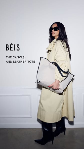 An ad for BÉIS canvas and leather tote bag. The ad features a model holding the bag in front of a white wall.