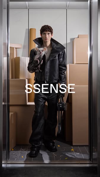 This ad features a person in a leather outfit holding a dog, standing in an elevator filled with boxes. The SSENSE logo 