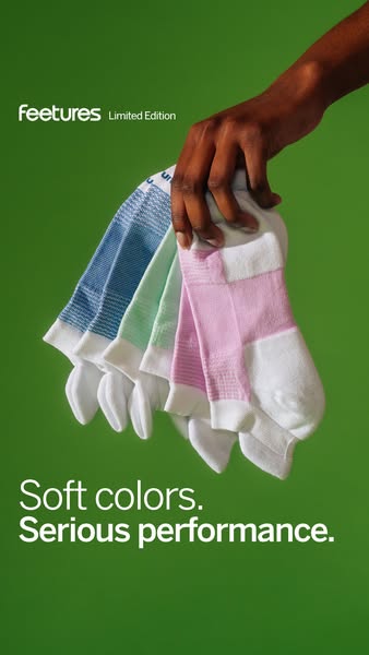 This ad for Feetures socks uses a hand to display the pastel colorways of its limited edition socks in front of a green 