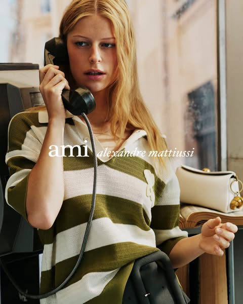 This ad features a young woman standing next to a payphone, holding the receiver to her ear. She is wearing a green and